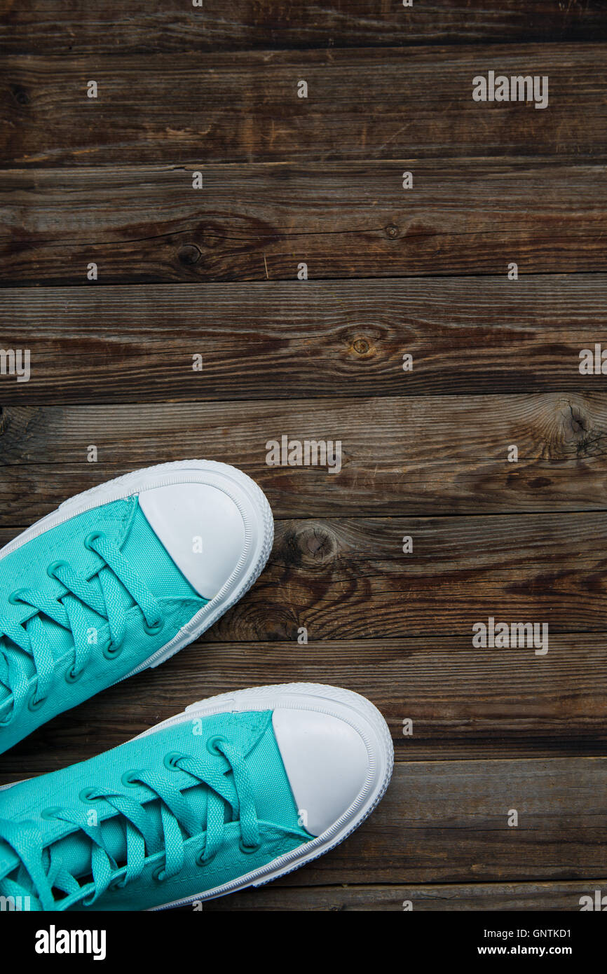 sneakers on empty wooden floor Stock Photo - Alamy