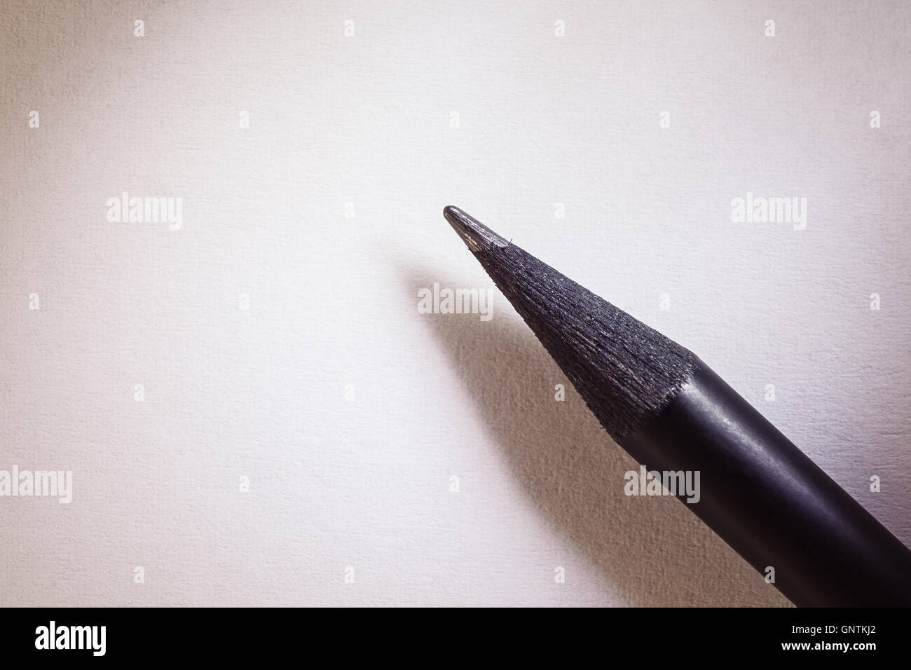 Closeup view of a graphite pen on white paper. Stock Photo