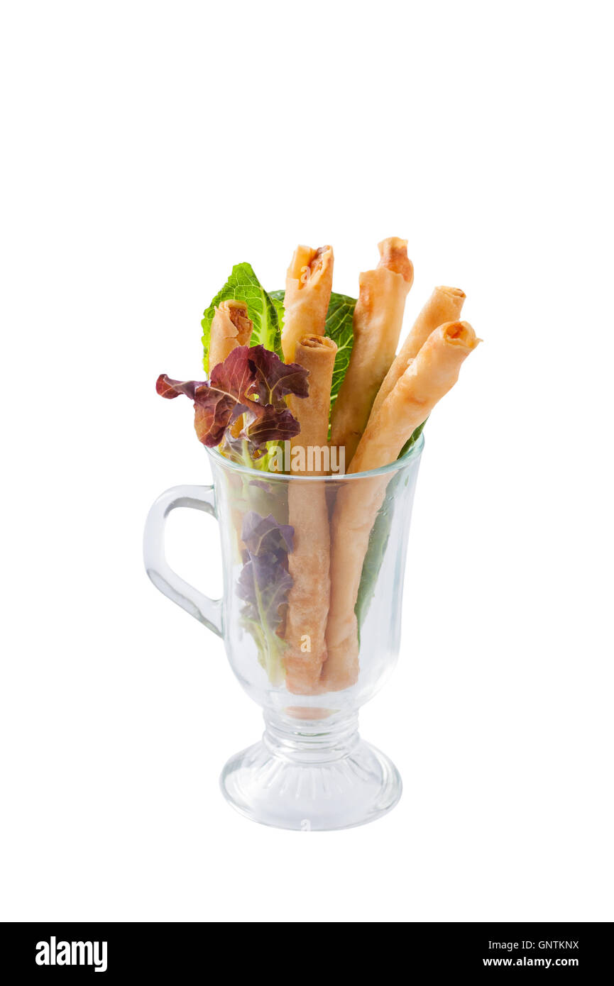 Front view of Chinese fusion style shrimp spring roll in glass isolated