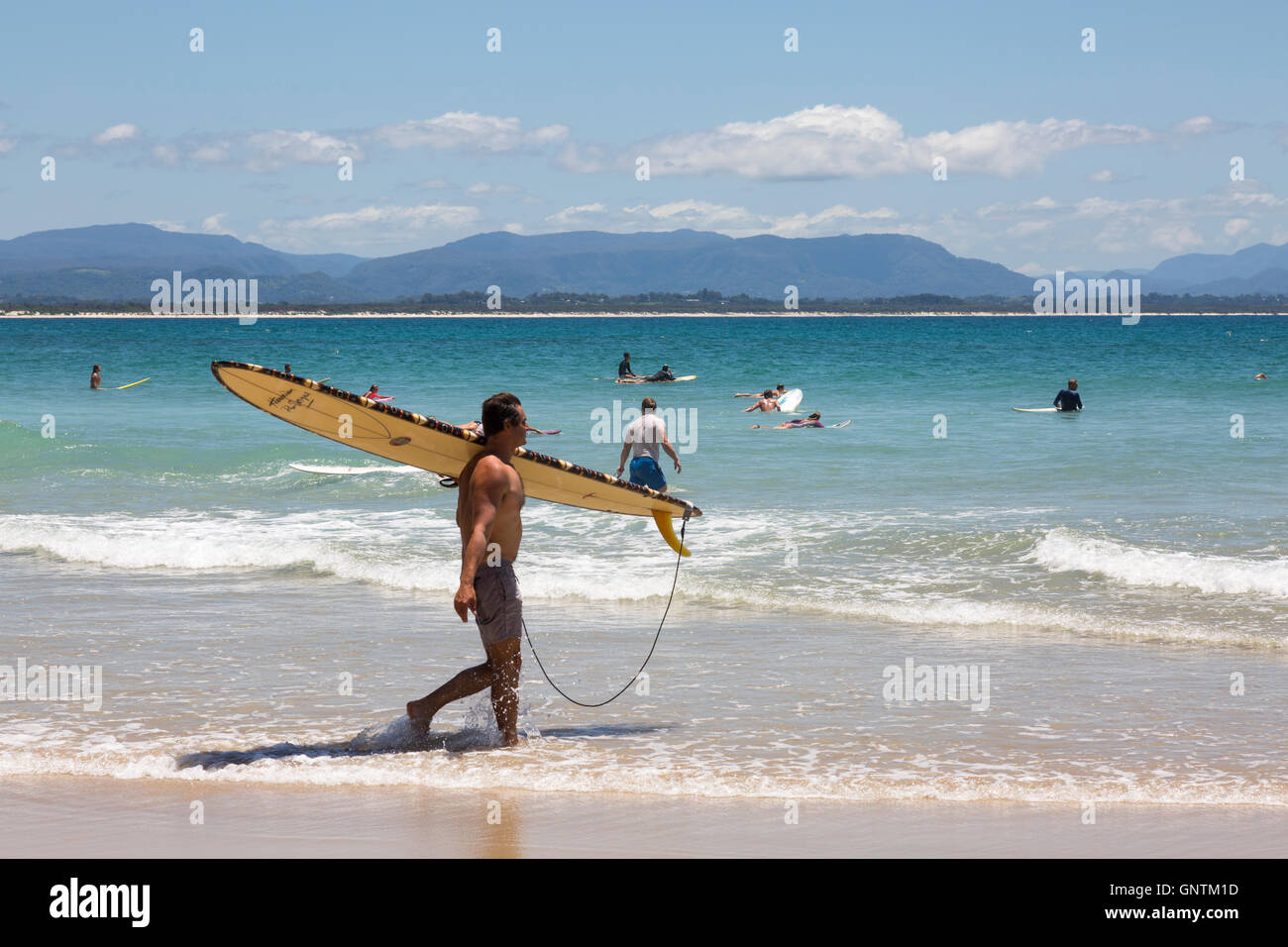 Surfers heading to the waves on Wategos Beach in Byron Bay,new south wales,australia Stock Photo