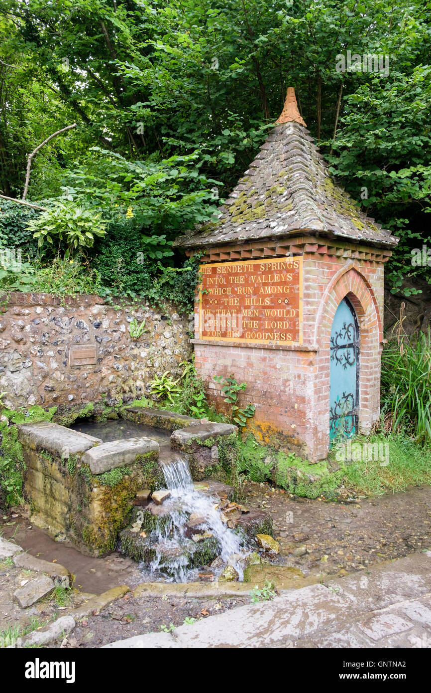 The Spring and Pump House with religious inscription in country village in South Downs National Park. Fulking Sussex England UK Stock Photo