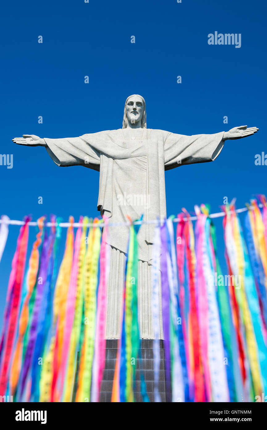 RIO DE JANEIRO - MARCH 21, 2016: Colorful religious Brazilian wish ribbons flutter in the wind at Christ the Redeemer. Stock Photo
