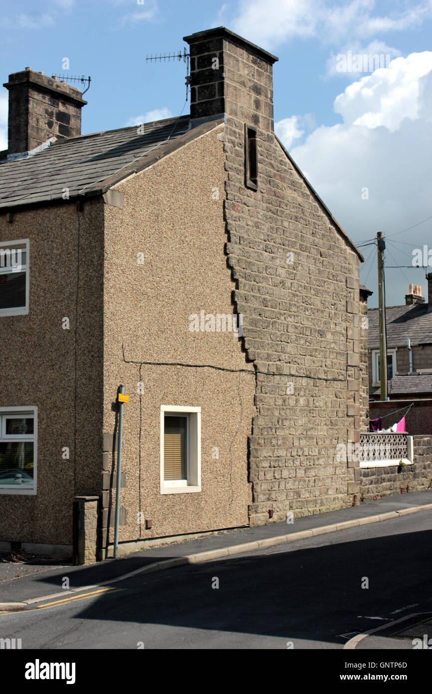 A stone built house in Barnoldswick has had some work done which includes rendering and pebble dashing part of a wall Stock Photo