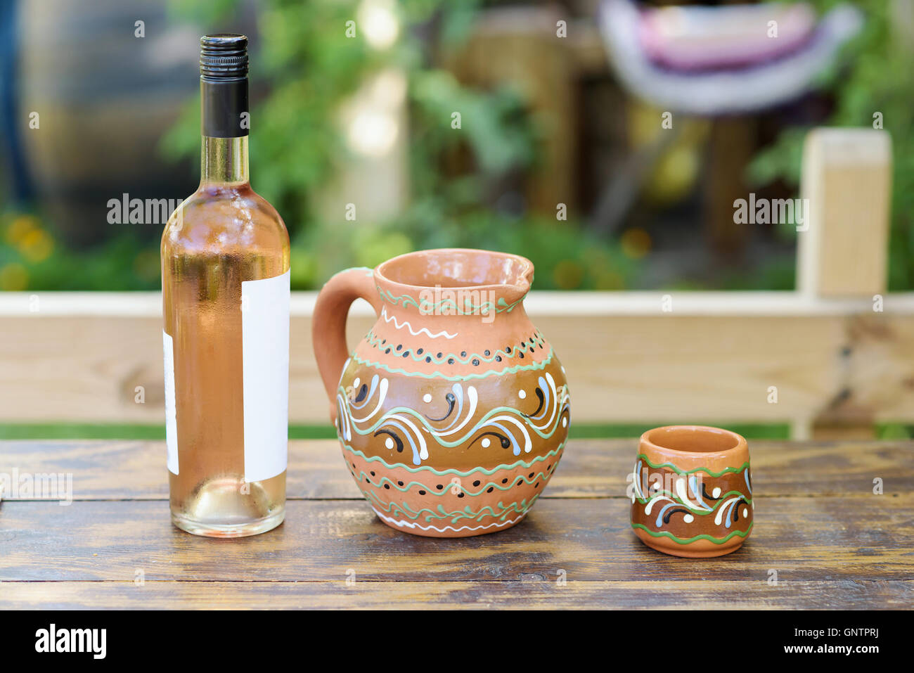 Rose wine bottle and traditional jag with ornaments on a restaurant table in Moldova Stock Photo