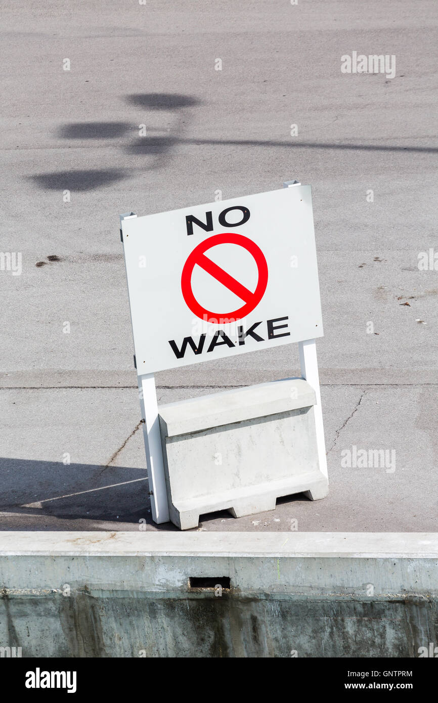 No Wake Sign on Concrete Pier Stock Photo