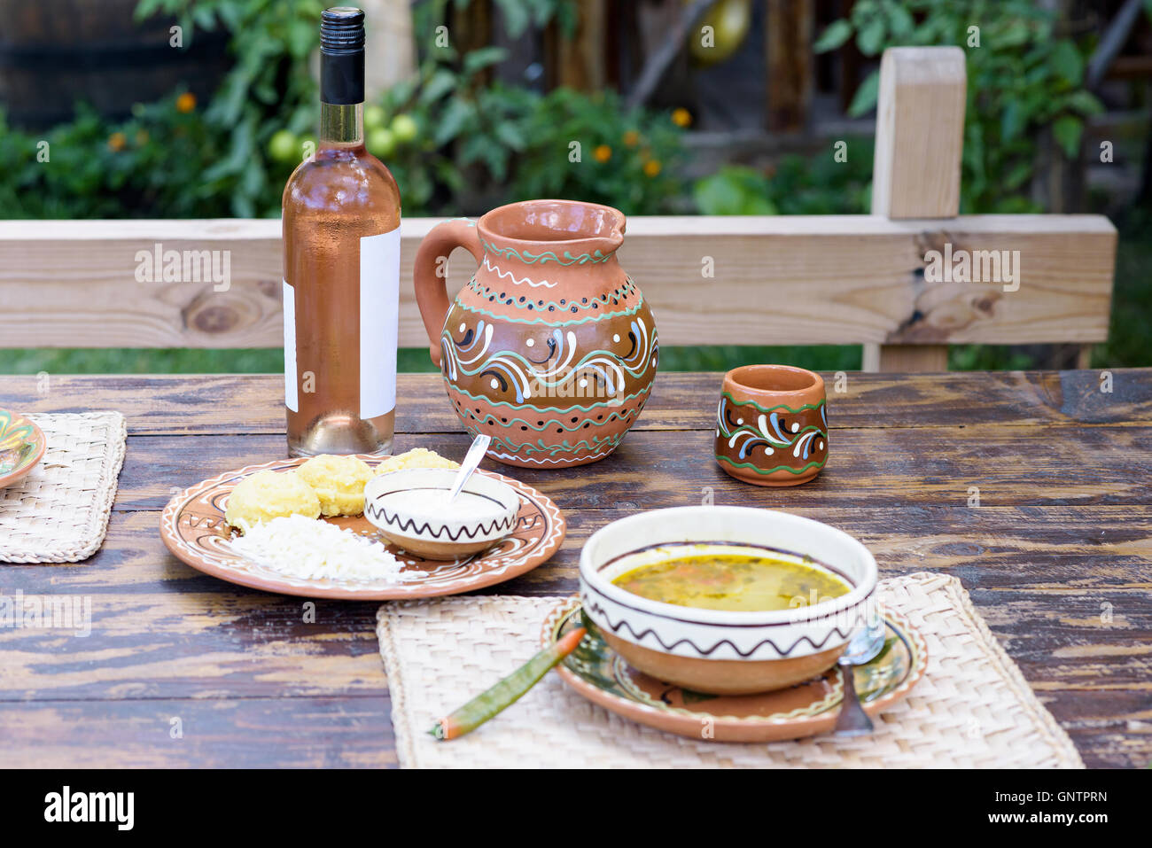 Rose wine bottle and traditional jag with ornaments, national food on a restaurant table in Moldova Stock Photo