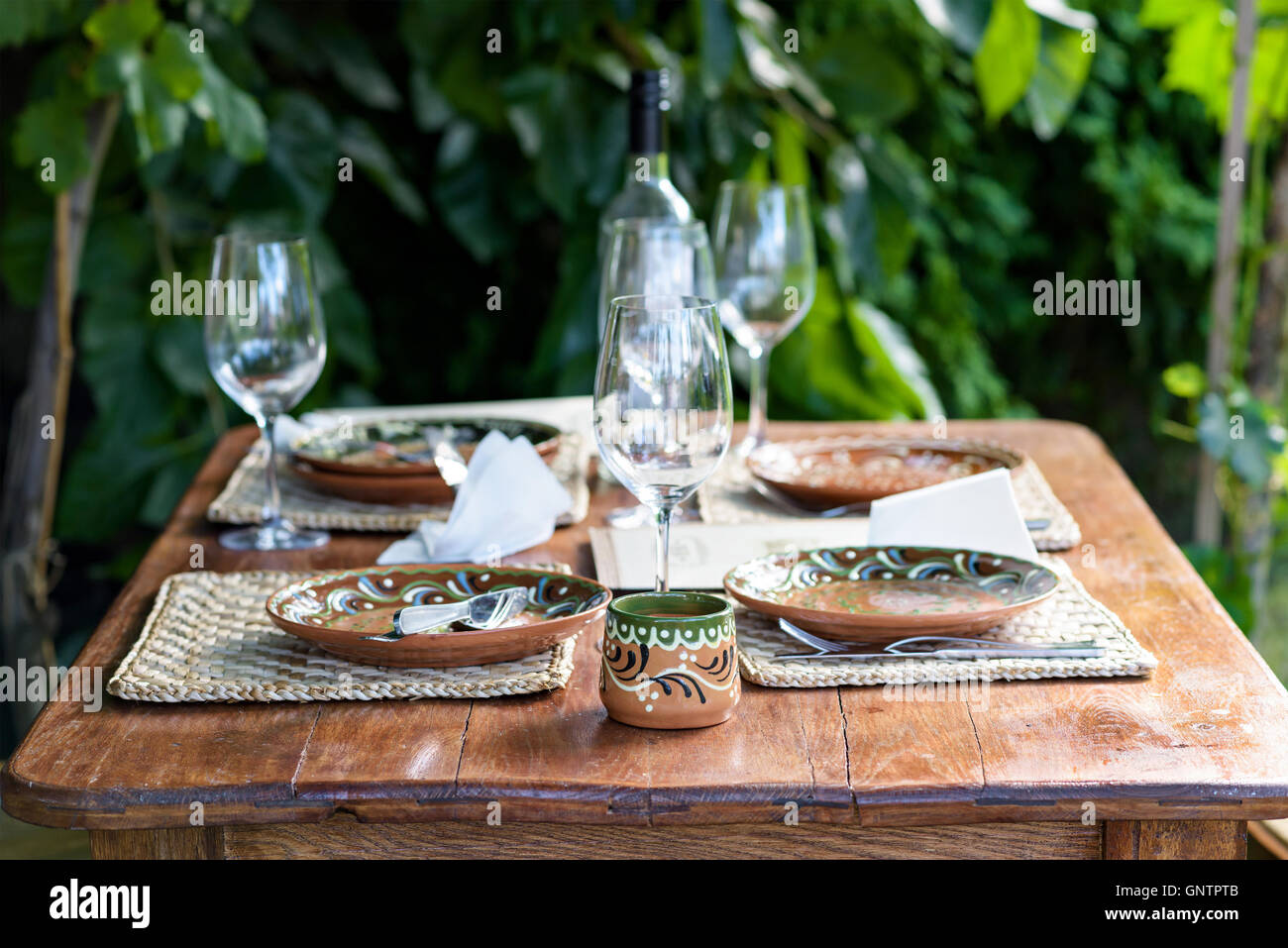 Empty traditional plates with ornaments on a restaurant table in Moldova, after finishing eating Stock Photo