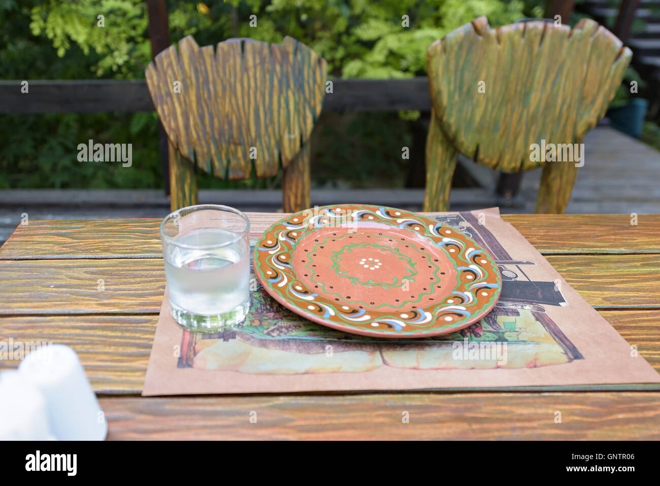 Traditional plate with ornaments and glass of water on a restaurant table in Moldova Stock Photo