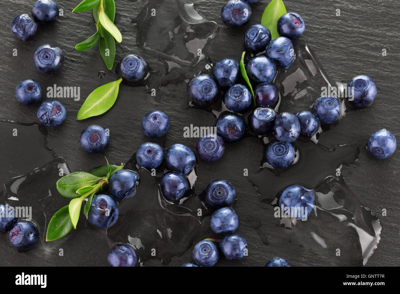 blueberries with ice on a slate table. Stock Photo