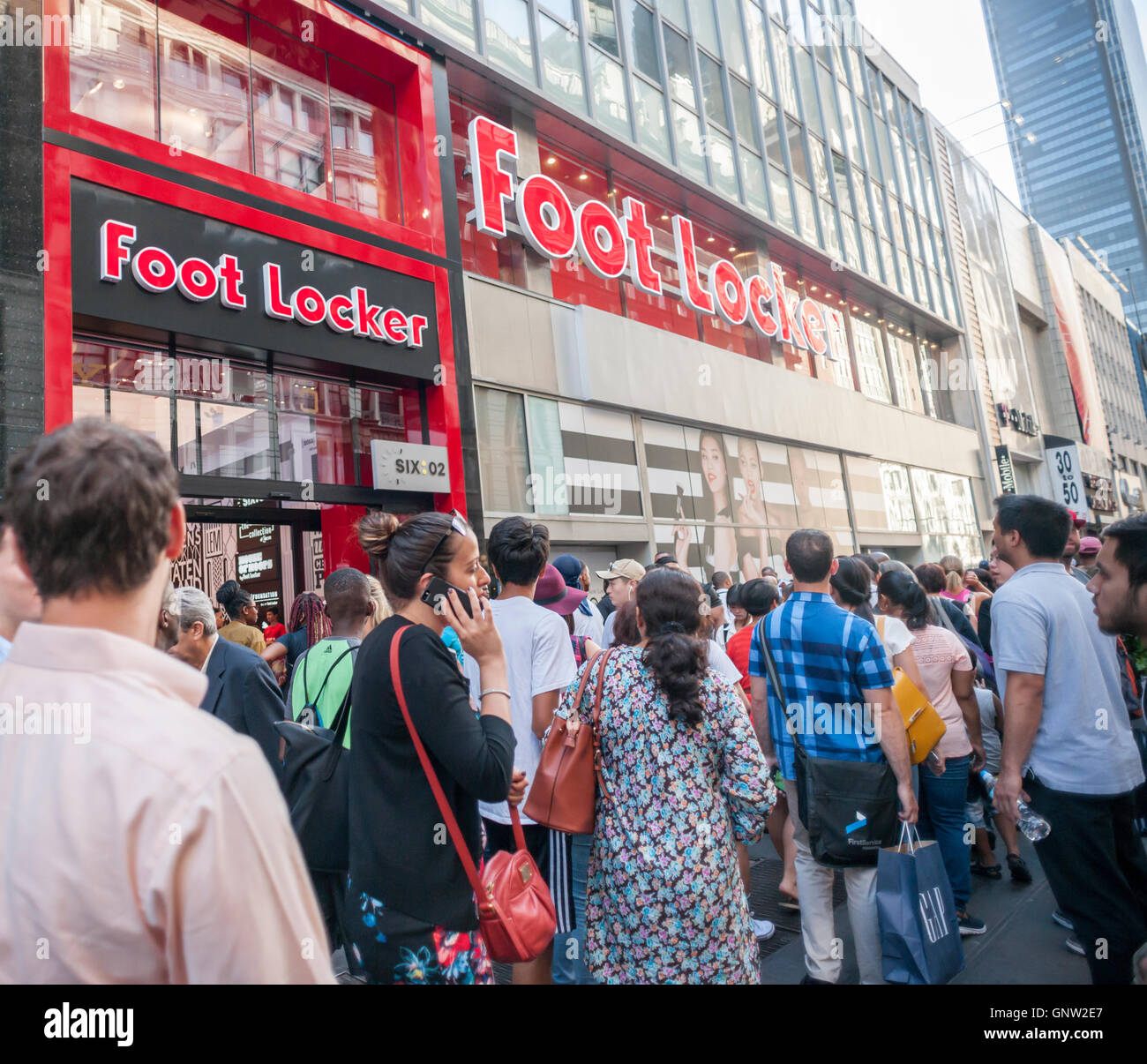 Hordes of shoppers outside the new experiential Foot Locker store in Herald Square in New York on opening day, Tuesday, August 30, 2016. The 10,000 square foot store is organized by brand as opposed to product category with separate areas for their Six:02, House of Hoops, and other brands. The store is on the second floor with a new Sephora to open at street level (hence the poster of the three models).  (© Richard B. Levine) Stock Photo