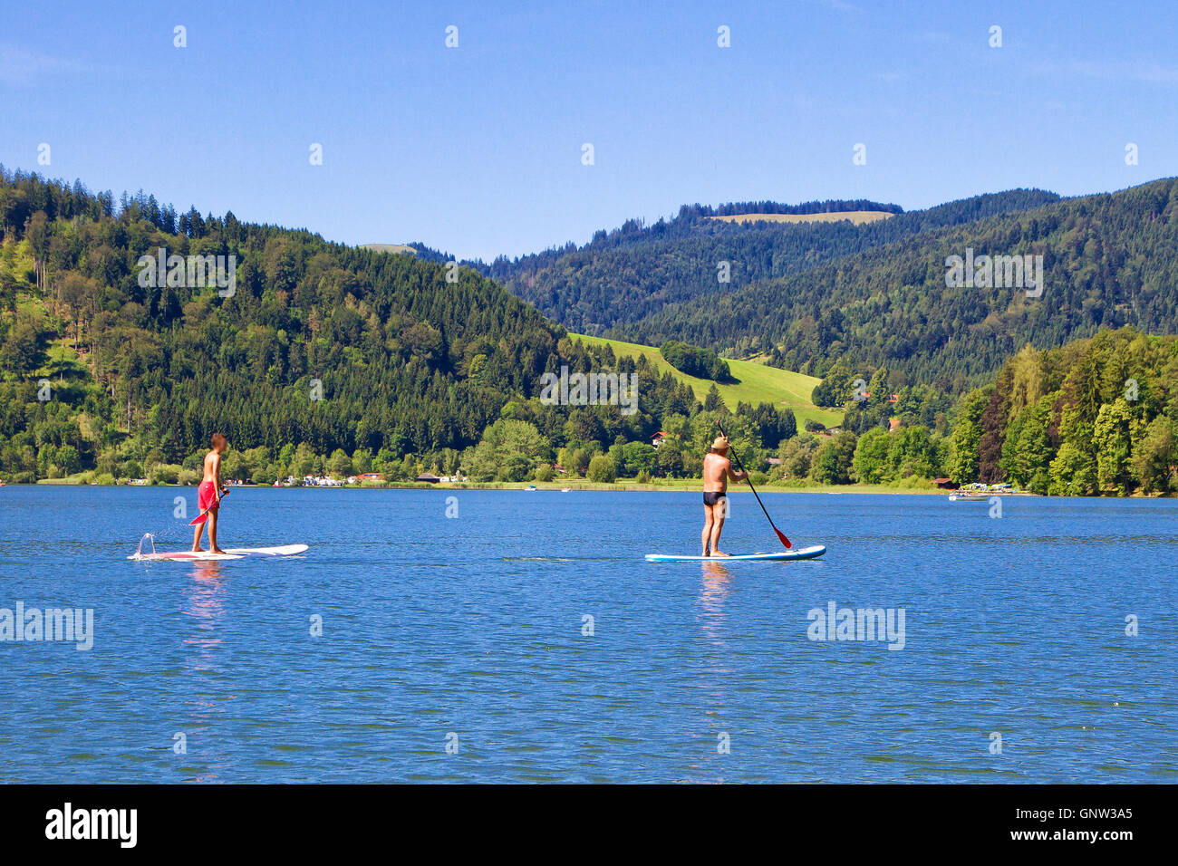 Stand up paddling on lake Schliersee, Bavaria, Germany Stock Photo