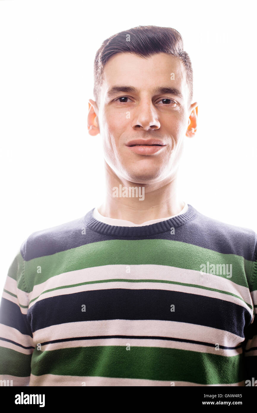 Portrait of a smart serious young man standing against white background ...