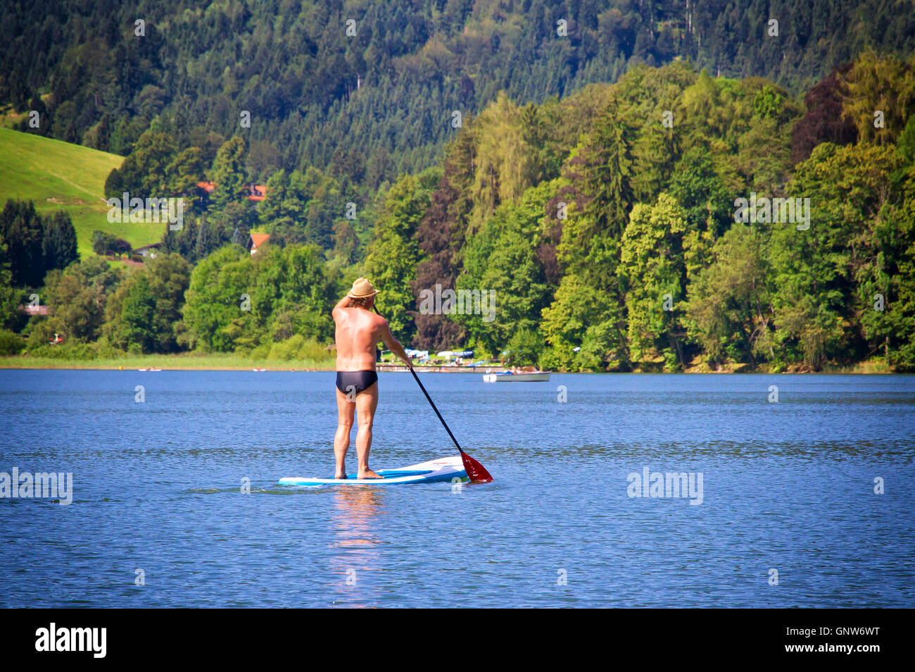 Stand up paddling on lake Schliersee, Bavaria, Germany Stock Photo