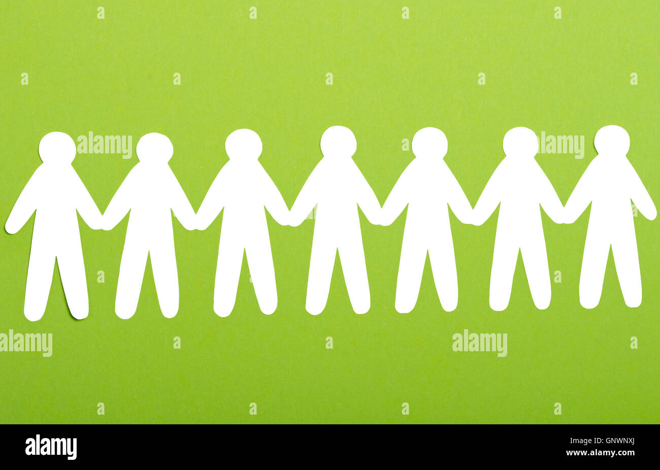 team of paper people on green background Stock Photo Alamy