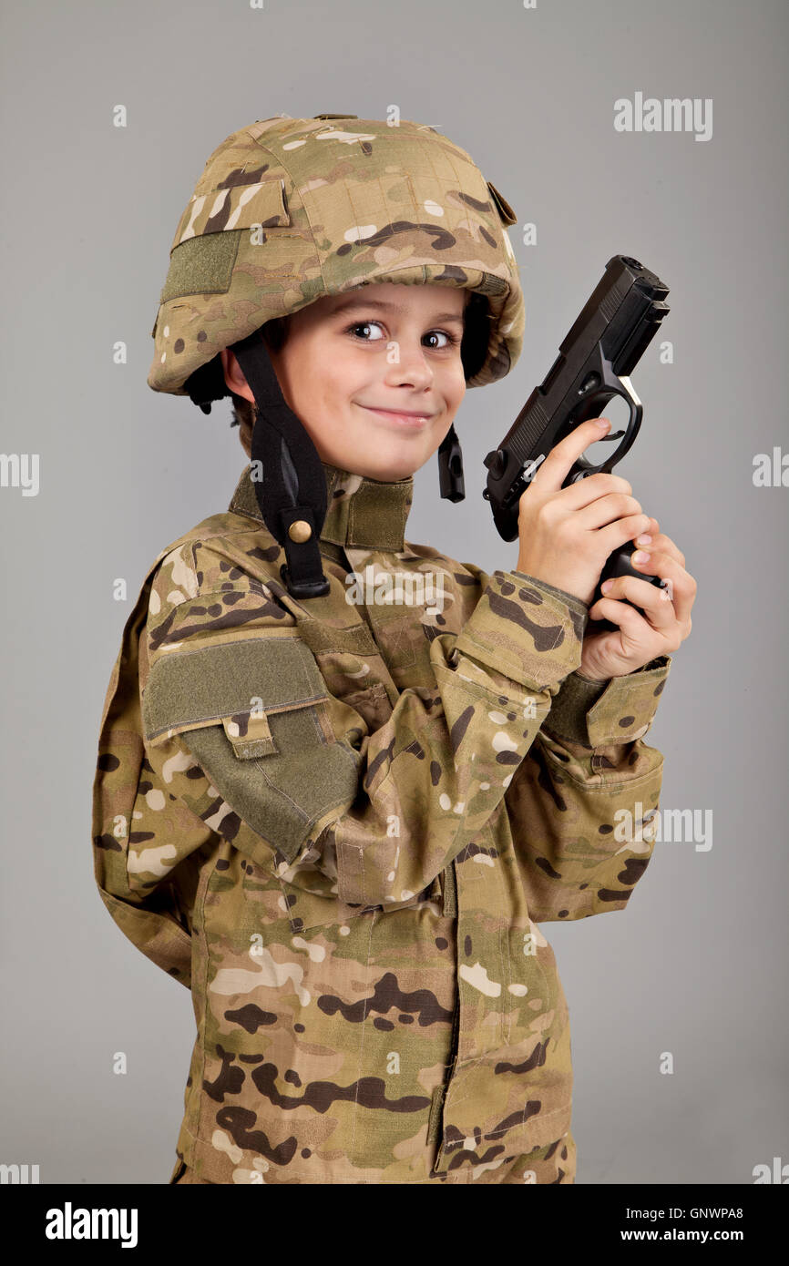 Young boy dressed like a soldier with a gun Stock Photo Alamy