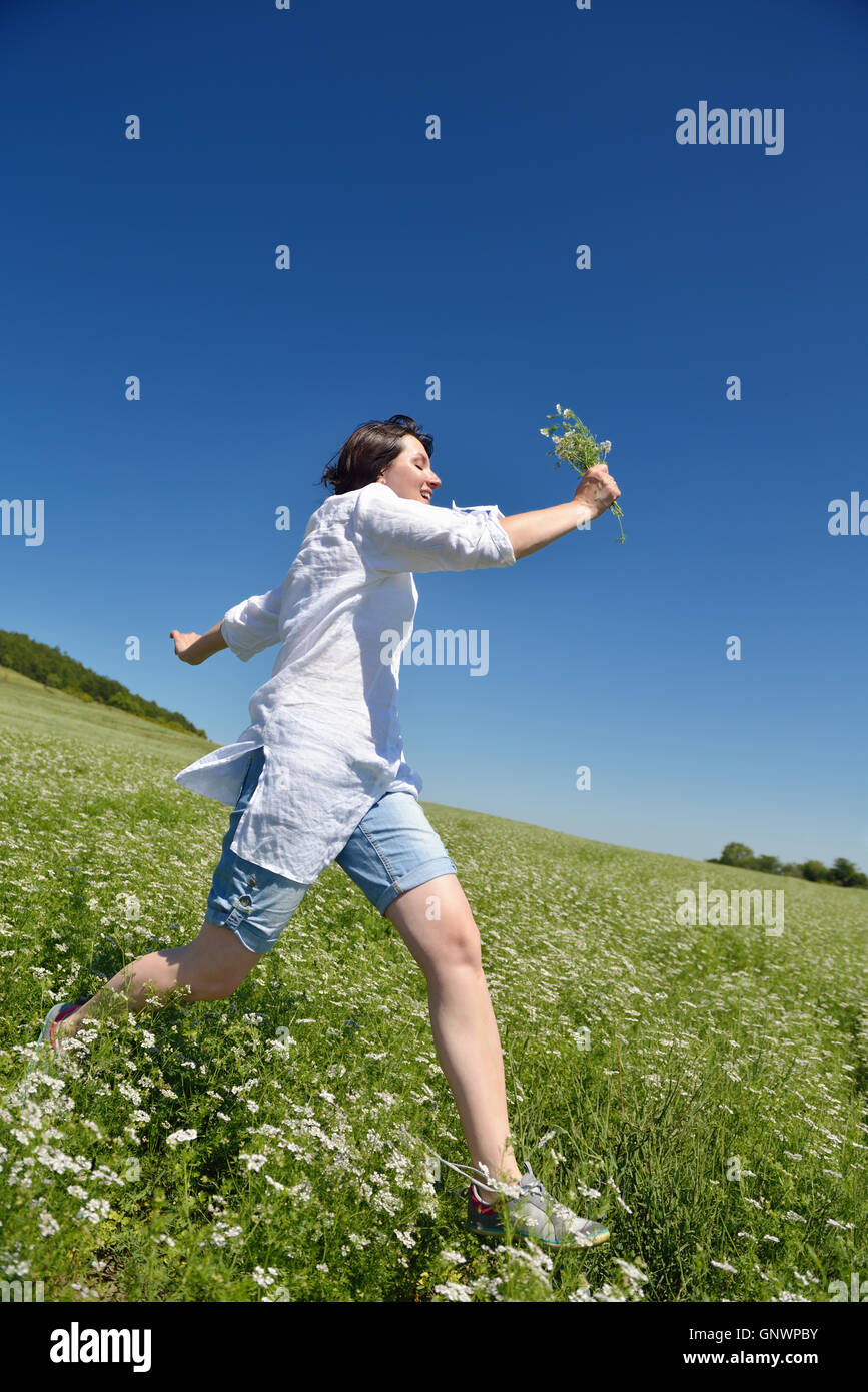 Young happy woman in green field Stock Photo - Alamy