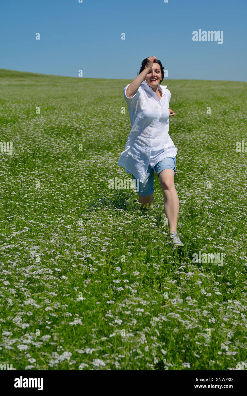 Young happy woman in green field Stock Photo - Alamy