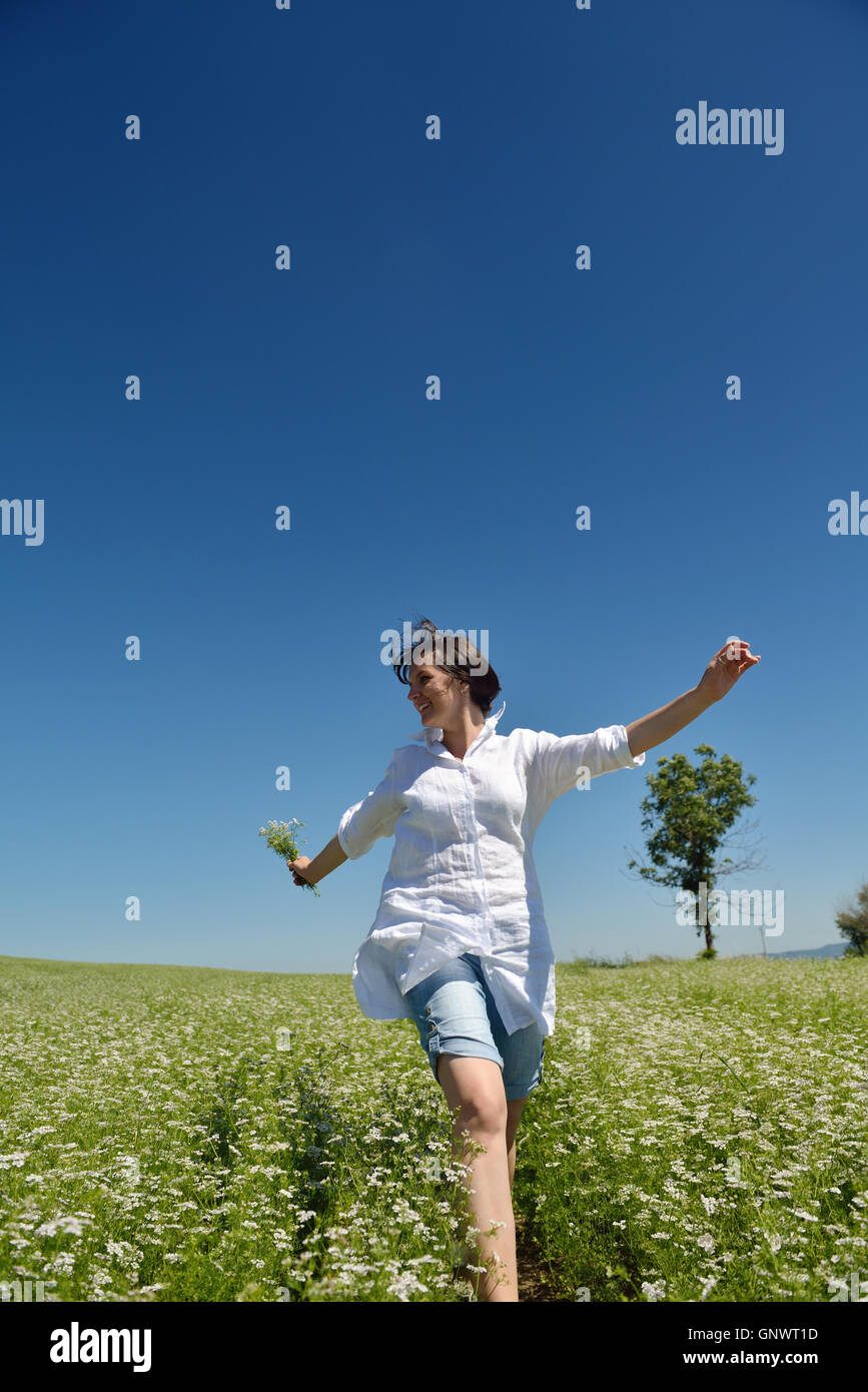 Young happy woman in green field Stock Photo - Alamy
