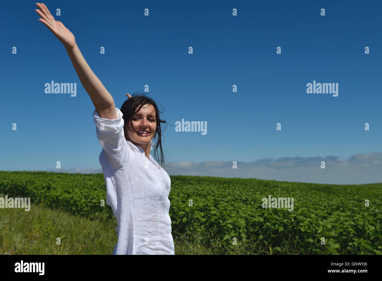 Young happy woman in green field Stock Photo - Alamy