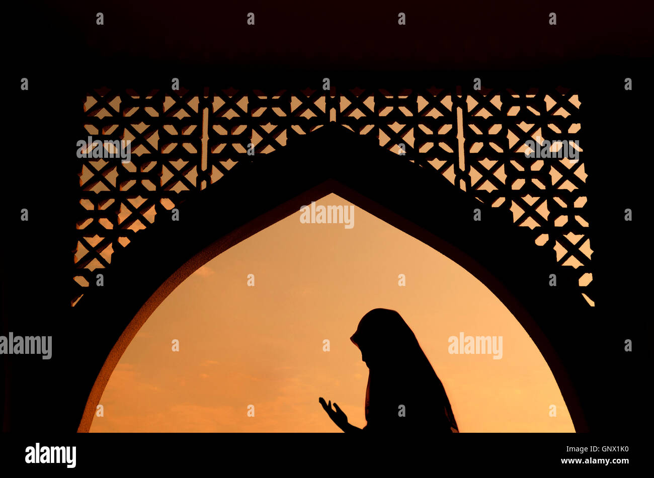 silhoutte of muslim woman praying Stock Photo