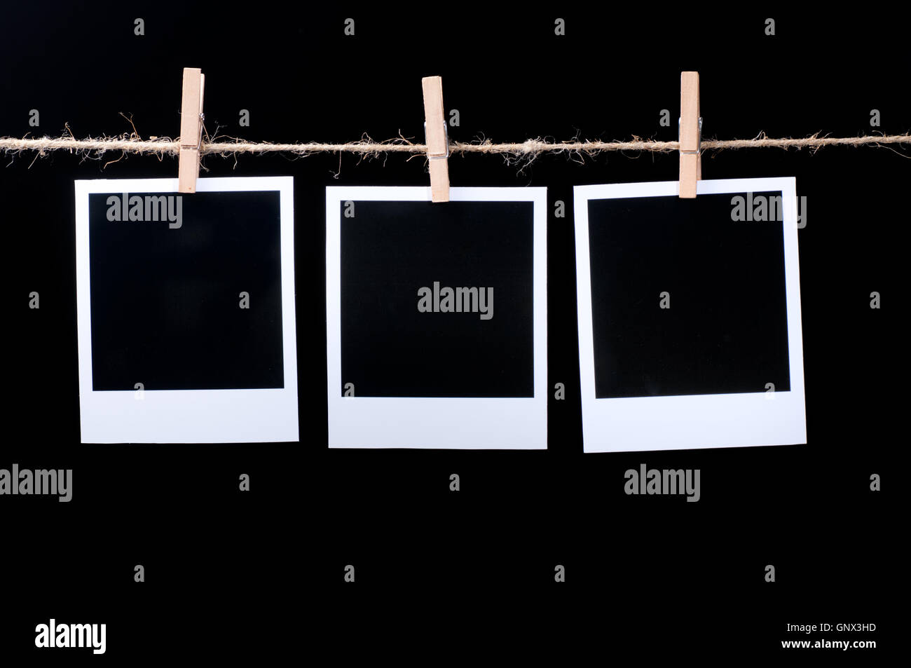 Blank photo frames on line on black Stock Photo - Alamy