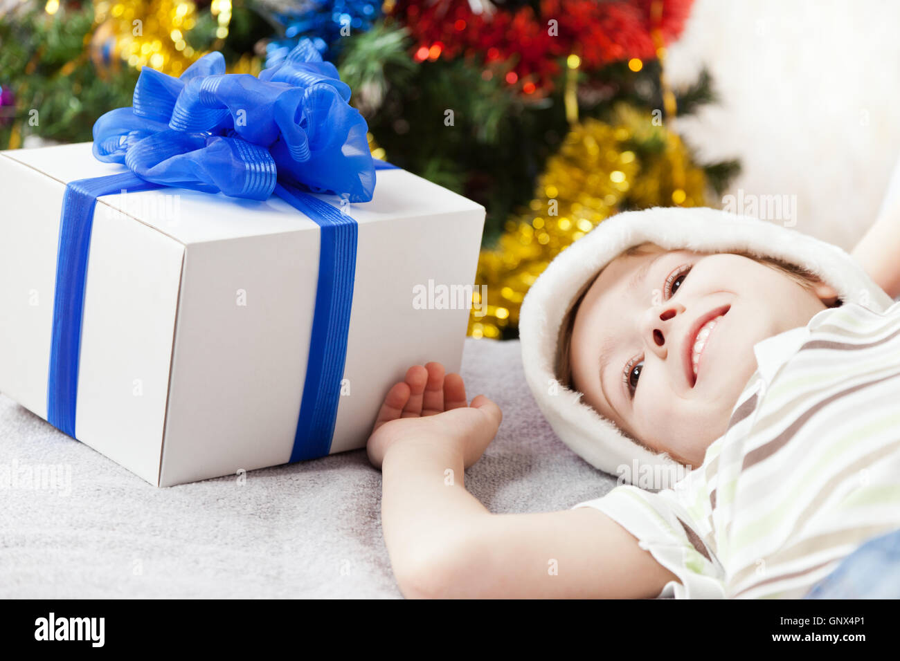 Smiling child boy with new year present or christmas holiday gif Stock Photo