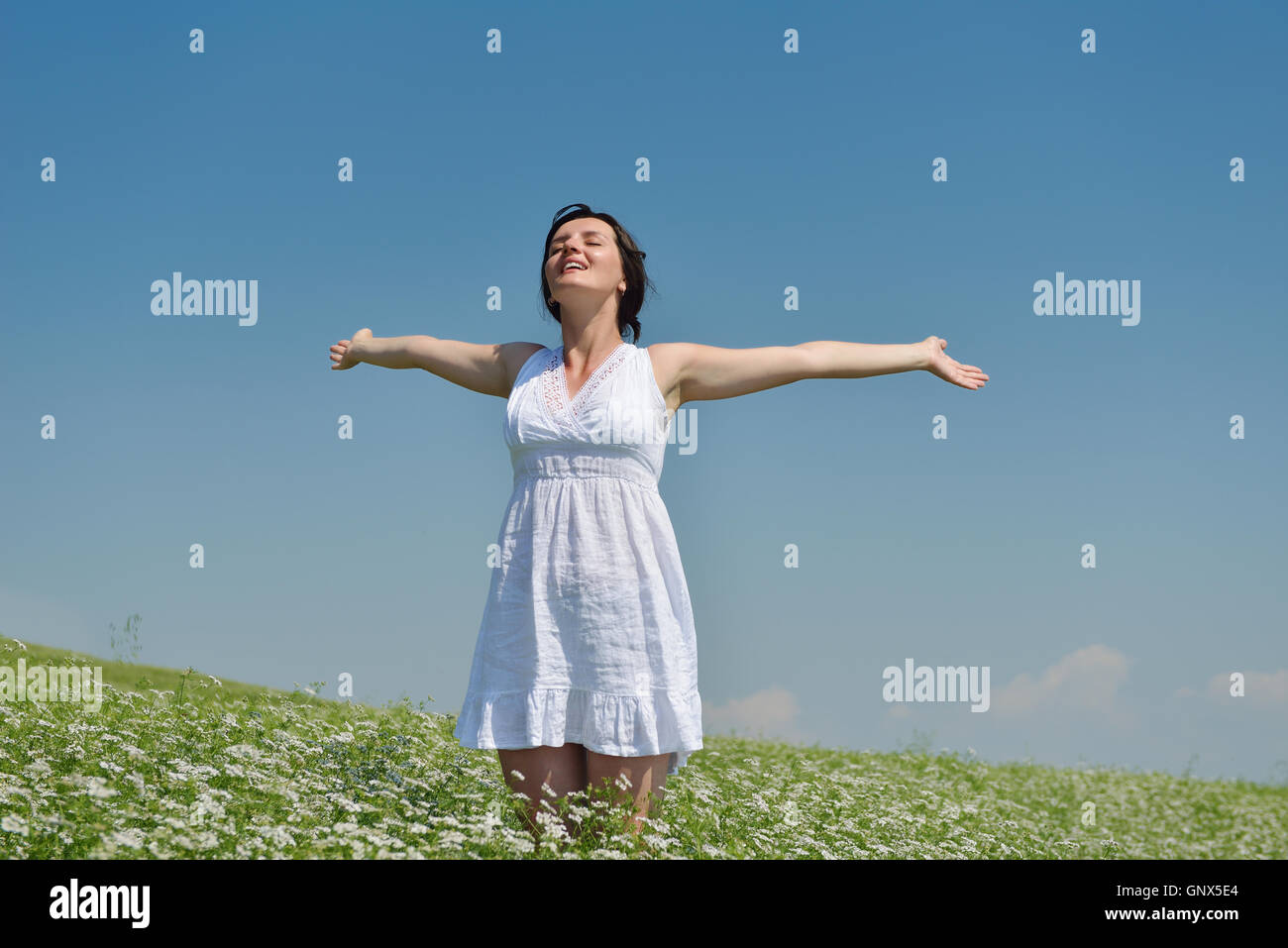 Young happy woman in green field Stock Photo - Alamy