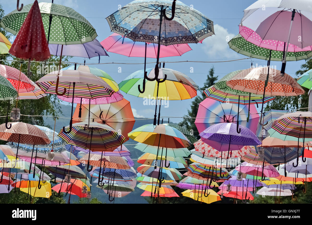 Creative decoration made of many hanging umbrellas on the street Stock