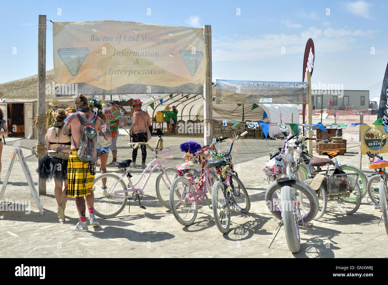 Burners stop at the BLM information center during the annual desert festival Burning Man August 30, 2016 in Black Rock City, Nevada. The annual festival attracts 70,000 attendees in one of the most remote and inhospitable deserts in America. Stock Photo