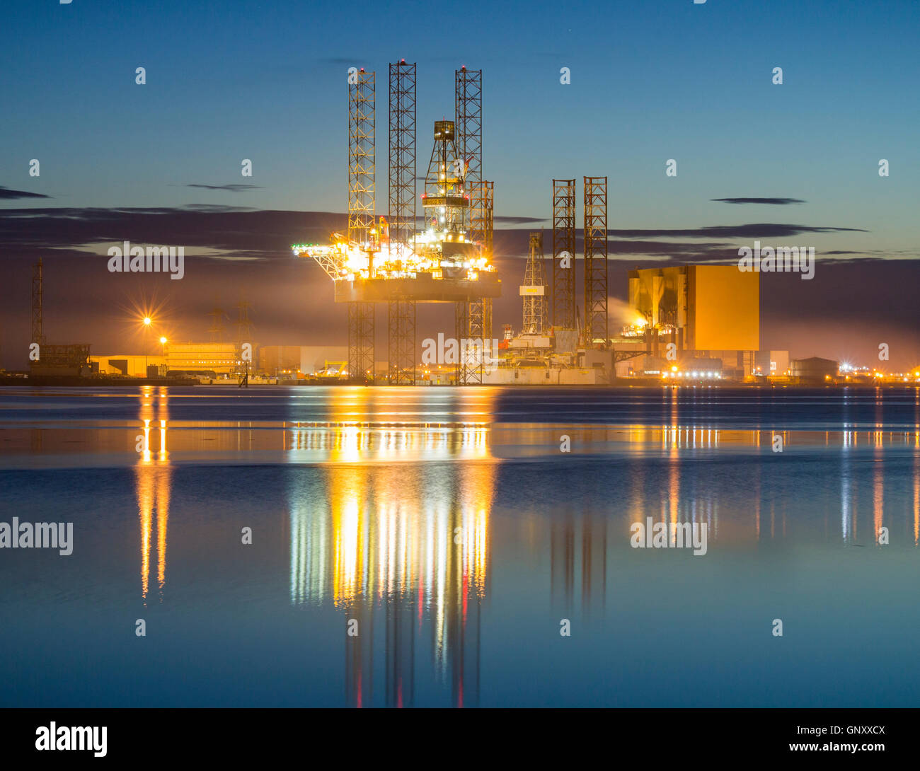 Hartlepool, north east England, UK. 1st Sep, 2016. Weather: A drilling platform in repair yard at Greatham Creek towers over Hartlepool nuclear power station (right) in pre dawn light on the first day of meteorological Autumn. Credit:  Alan Dawson News/Alamy Live News Stock Photo
