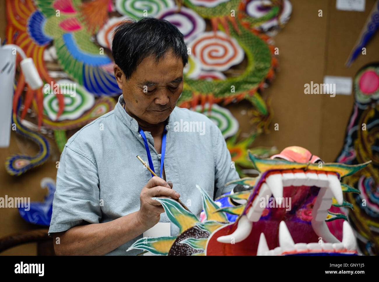 Hangzhou, China's Zhejiang Province. 1st Sep, 2016. Folk artist Cheng Dishen paints on a dragon-shaped kite at the Hangzhou Arts and Crafts Museum in Hangzhou, capital city of east China's Zhejiang Province, Sept. 1, 2016. Traditional handicrafts and local intangible cultural heritages were demonstrated in the museum. © Li Xiang/Xinhua/Alamy Live News Stock Photo