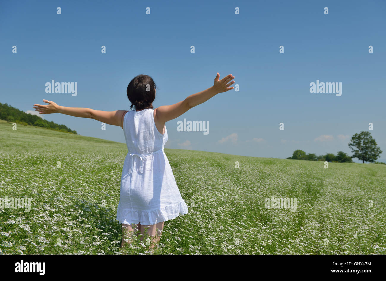 Young happy woman in green field Stock Photo - Alamy