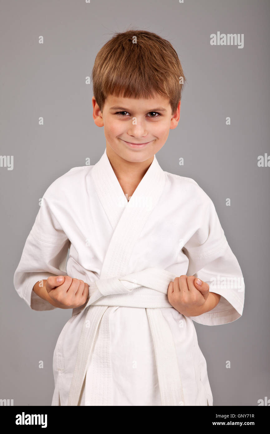 Karate boy in white kimono fighting Stock Photo