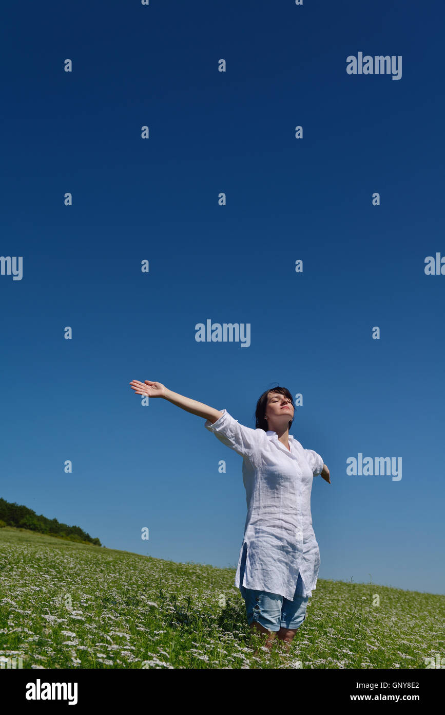 Young happy woman in green field Stock Photo - Alamy