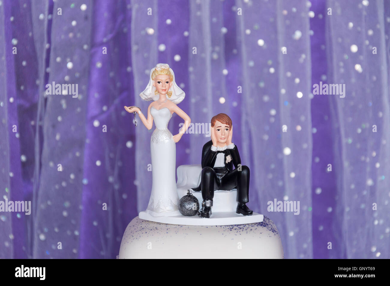 Humorous bride and groom figures on top of wedding cake, Staines-upon-Thames, Surrey, England, United Kingdom Stock Photo