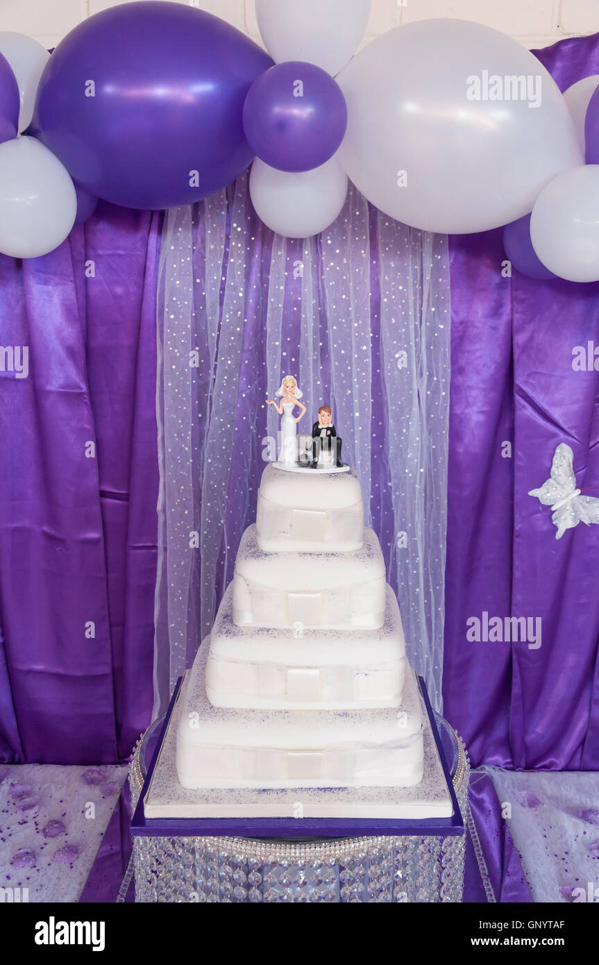 Humorous bride and groom figures on top of wedding cake, Staines-upon-Thames, Surrey, England, United Kingdom Stock Photo