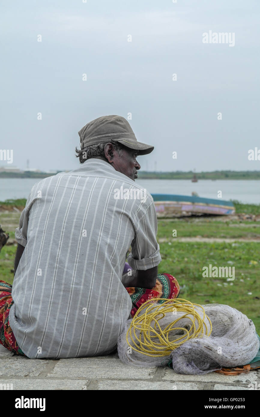 Indian Fisherman Sitting Near The Sea In Fort Kochi Kerala