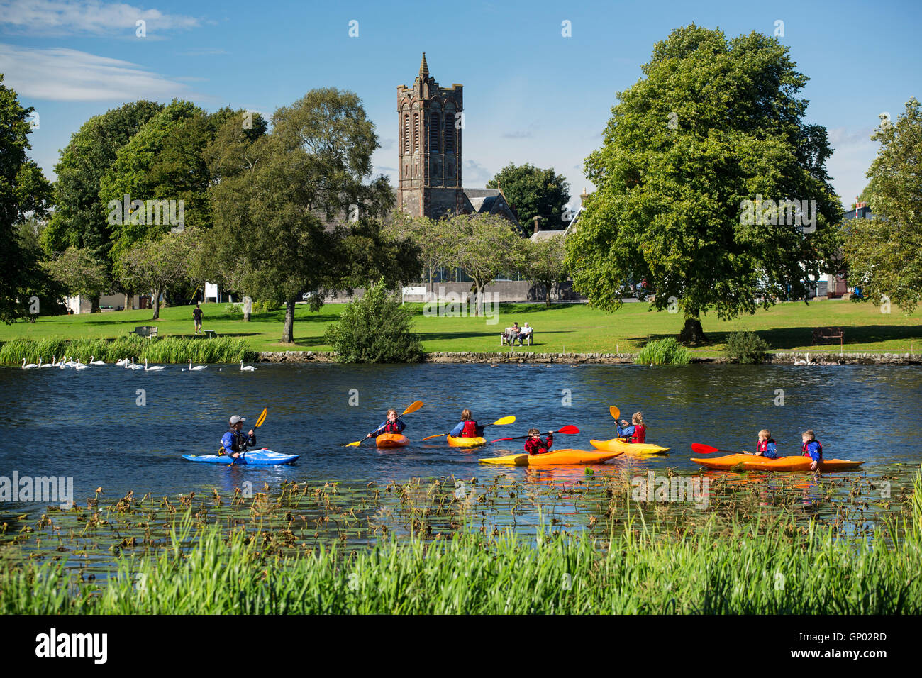 Carlingwark Loch at Castle Douglas. Children learning to canoe on the loch on a bright summer day. Dumfries and Galloway Stock Photo