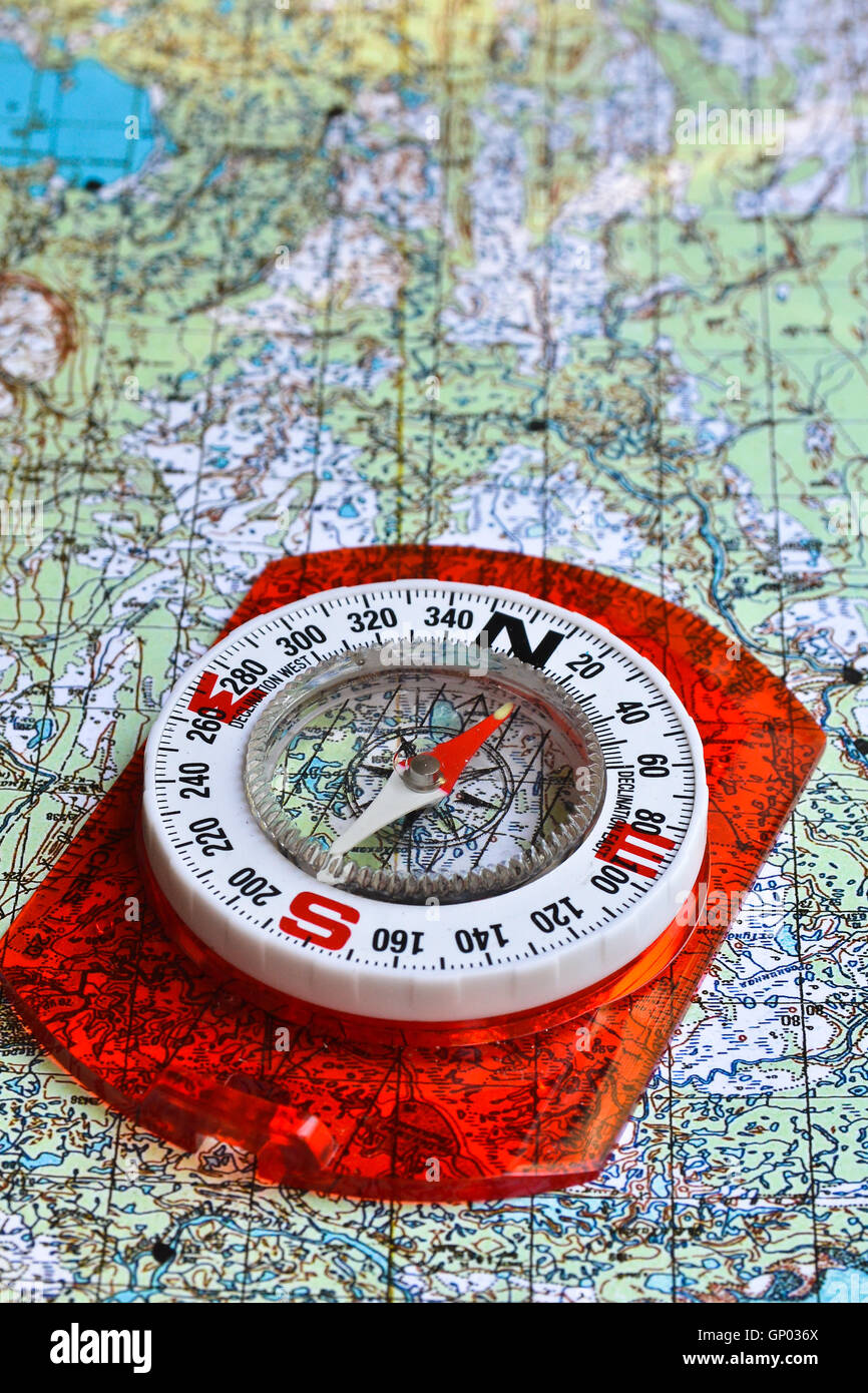 No orientation no travel. The tools of orienteering - map and a magnetic compass. Stock Photo