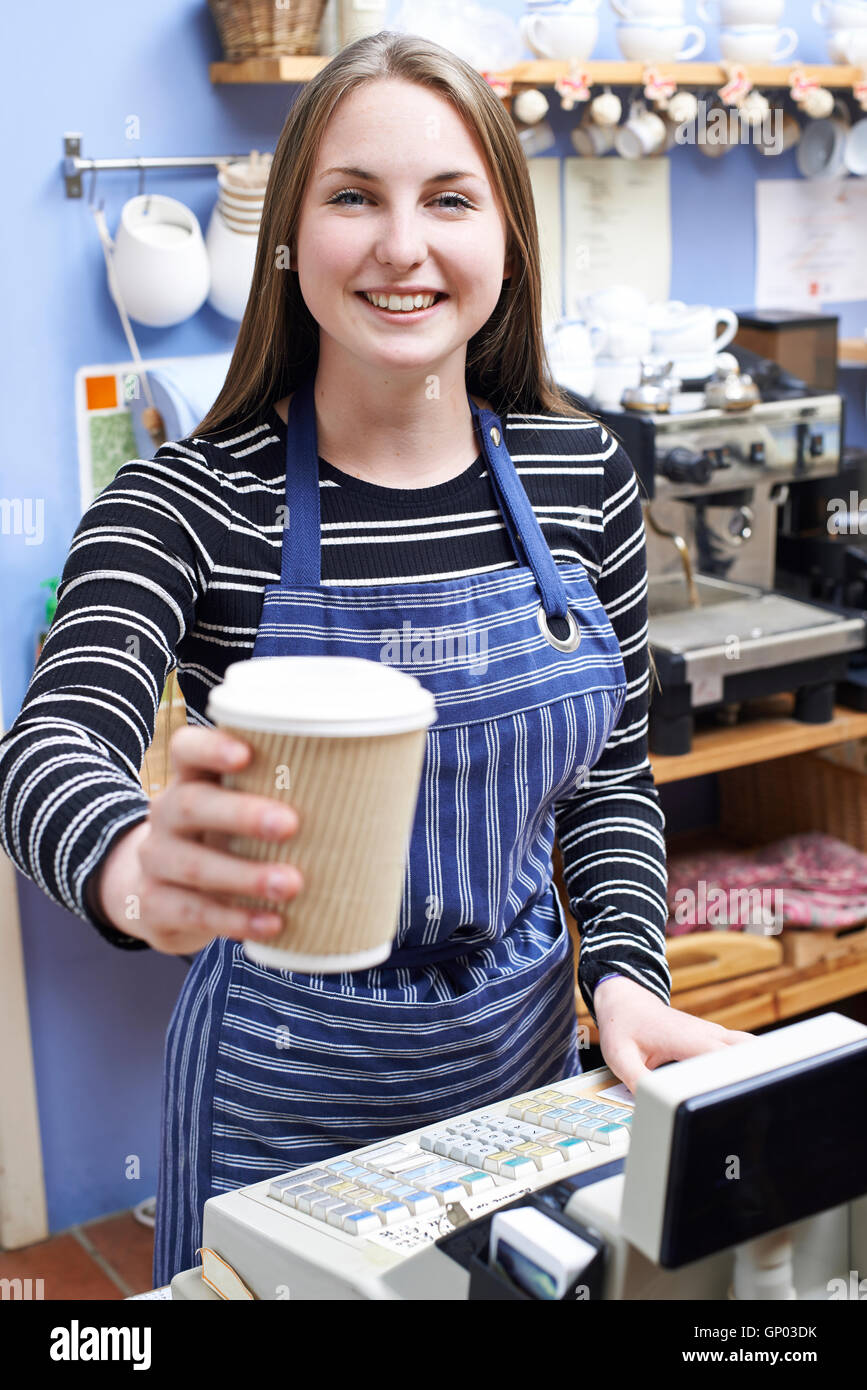 Waitress In Cafe Serving Customer With Takeaway Coffee Stock Photo