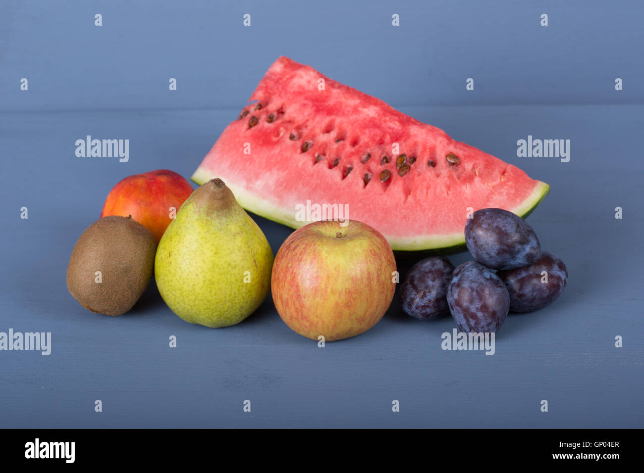 fruits on a blue wooden table, studio picture Stock Photo - Alamy