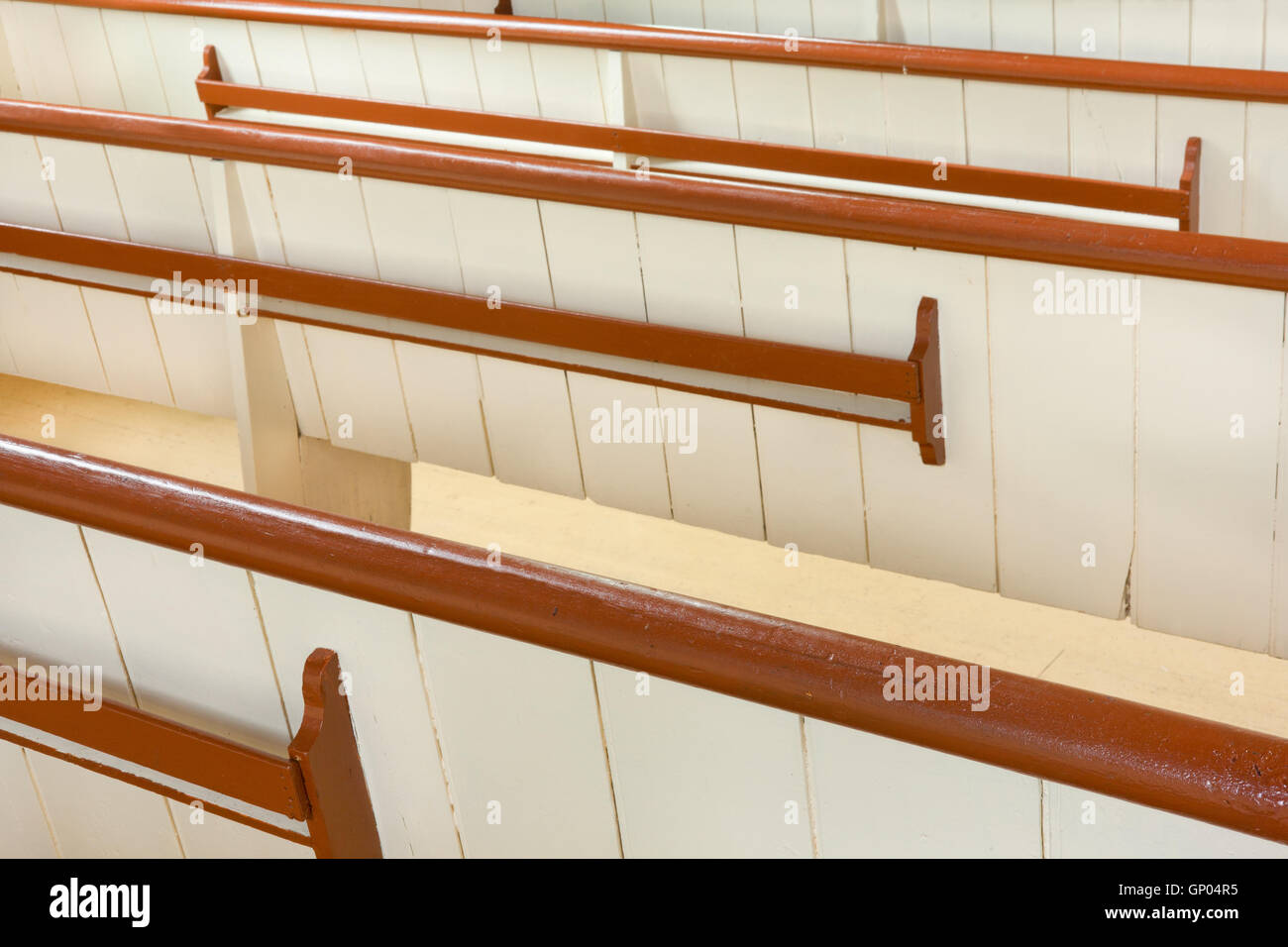 Detail view from behind of wooden church pews. Stock Photo