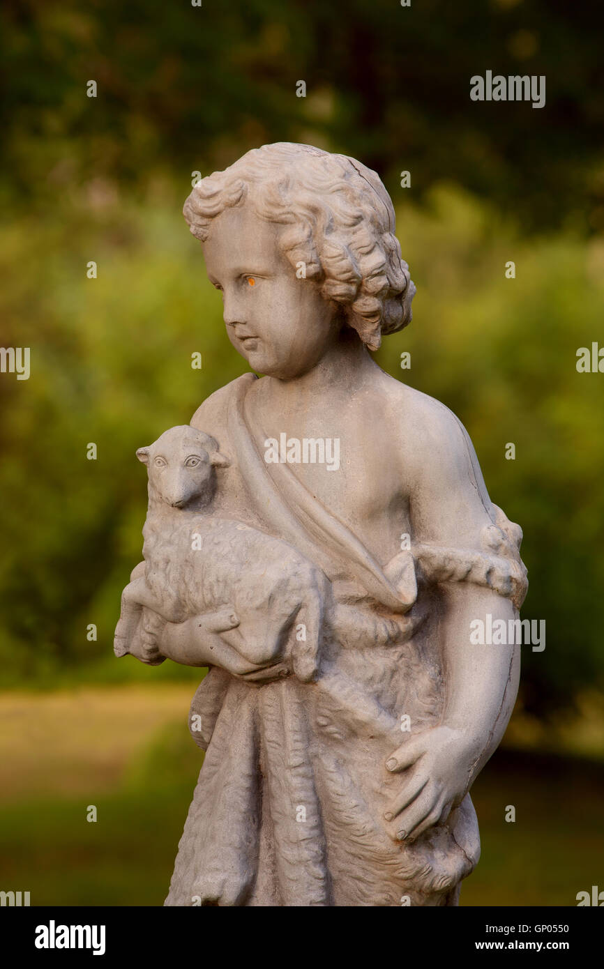Statue of young boy holding lamb Stock Photo - Alamy