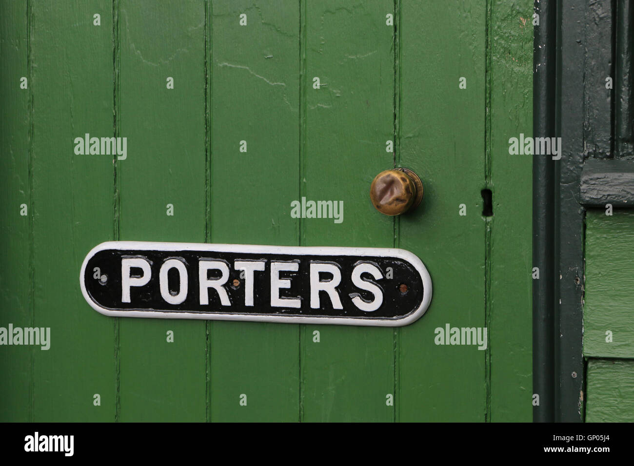 Plaque fixed to closed, green, wooden door of a porters' cabin at a heritage railway station Stock Photo