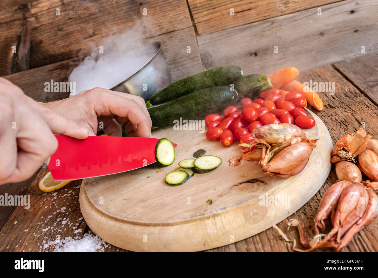 Chef cuts fresh vegetables essential ingredients of typical and healthy Italian cuisine Stock Photo