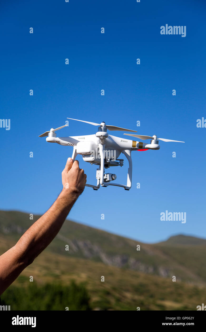 Male hand holding a white drone Stock Photo