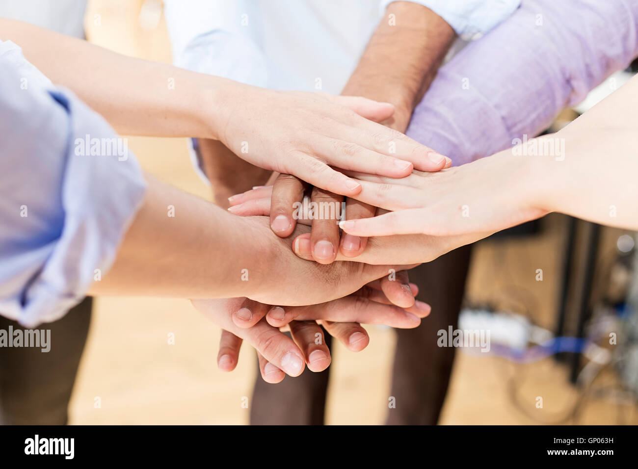 Close up view at group of hands holding together Stock Photo