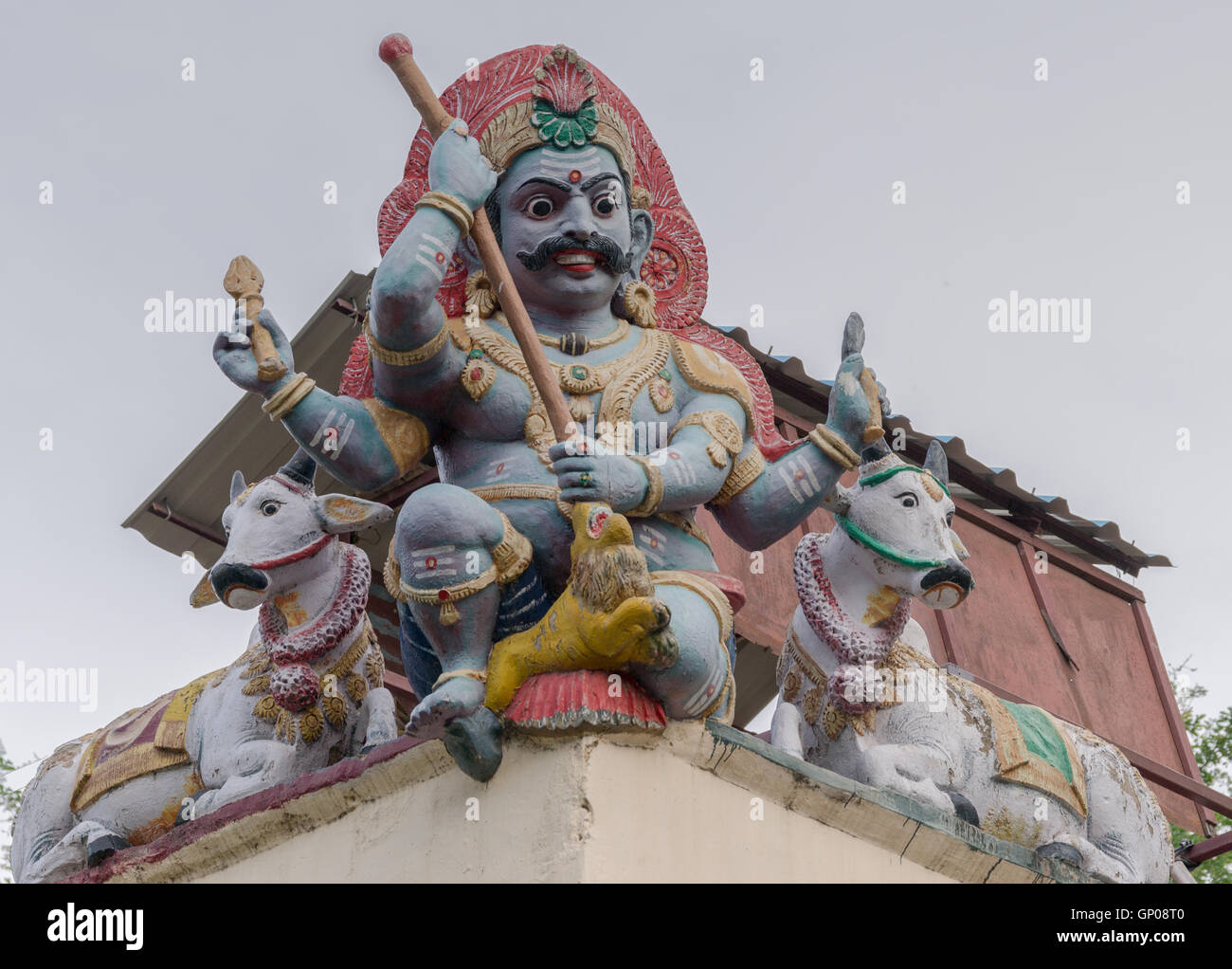 Male Gana keeps guard on corner of temple wall. Stock Photo