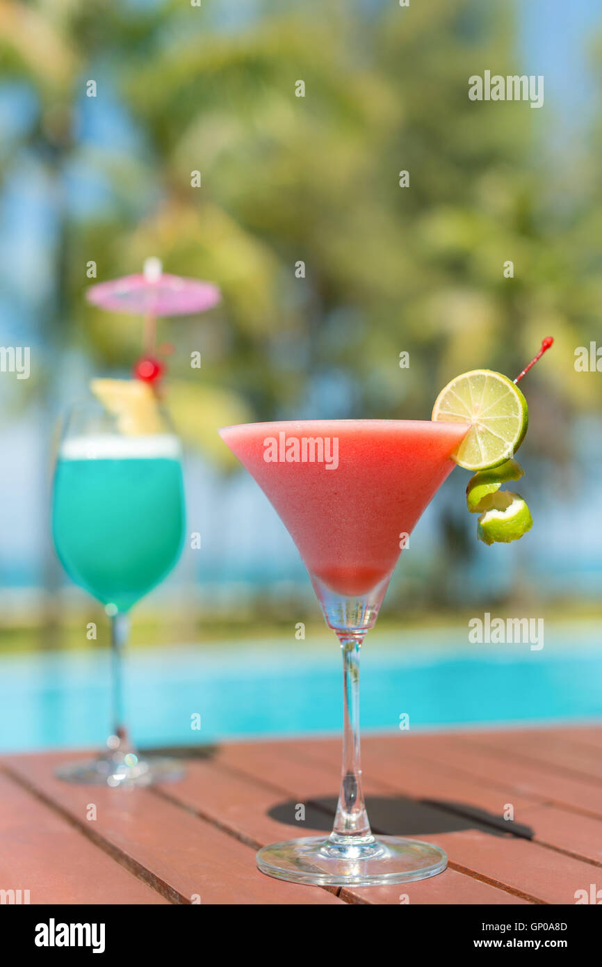 Cocktail glasses at pool, beach side. Stock Photo