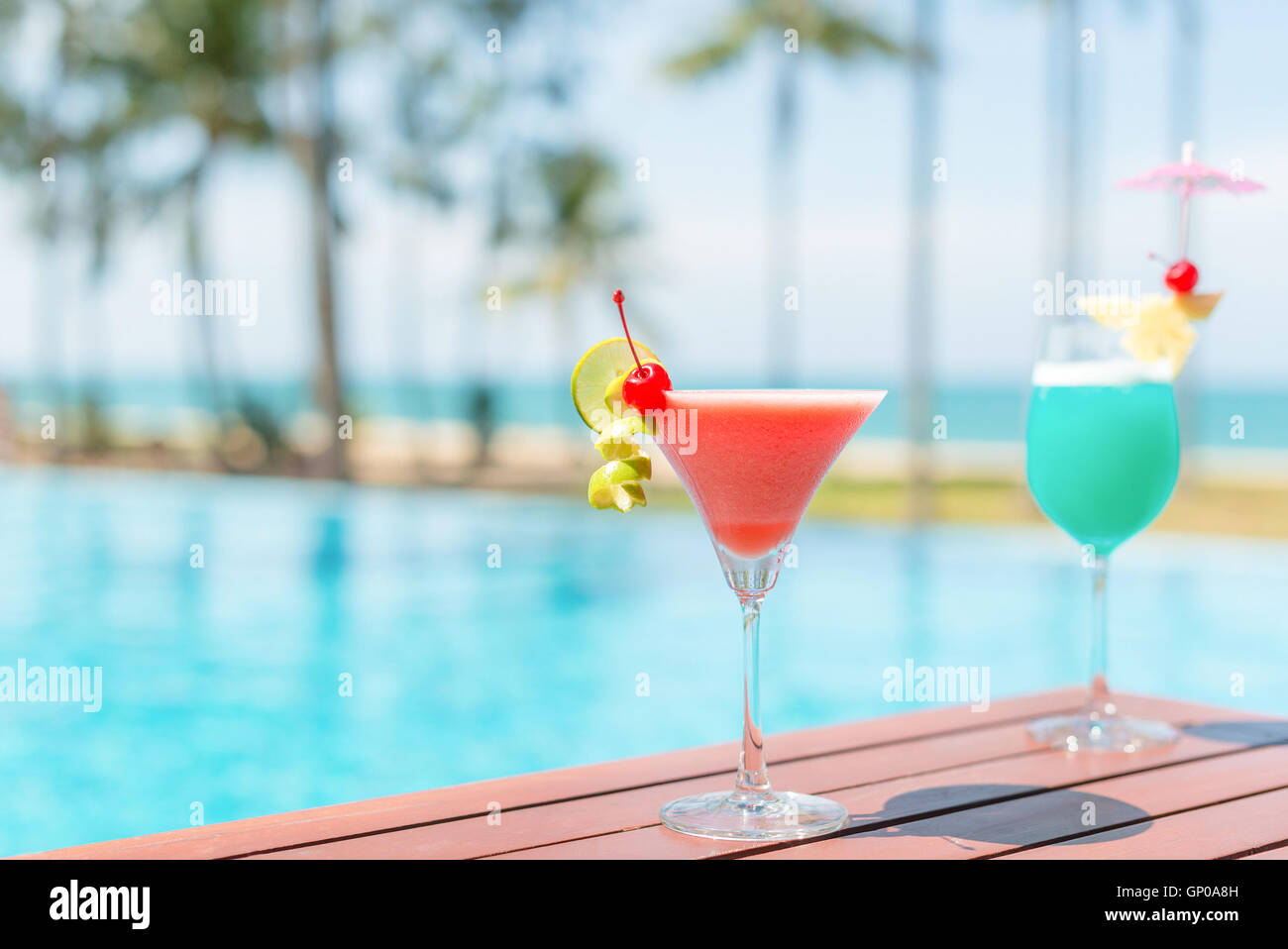 Cocktail glasses at pool, beach side. Stock Photo